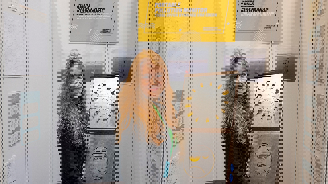 The Big Bang Competition UK Young Engineer of the Year winner holds a model of their winning entry, a portable pollution monitor