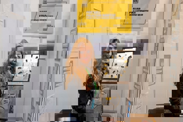 The Big Bang Competition UK Young Engineer of the Year winner holds a model of their winning entry, a portable pollution monitor