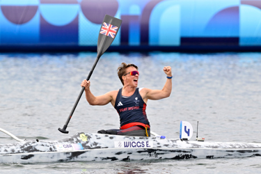 Emma Wiggs at the Paralympics celebrating in a canoe