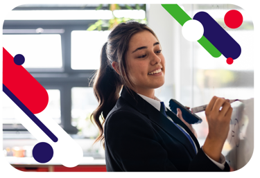 Young person writing on a whiteboard and smiling. They are wearing school uniform.