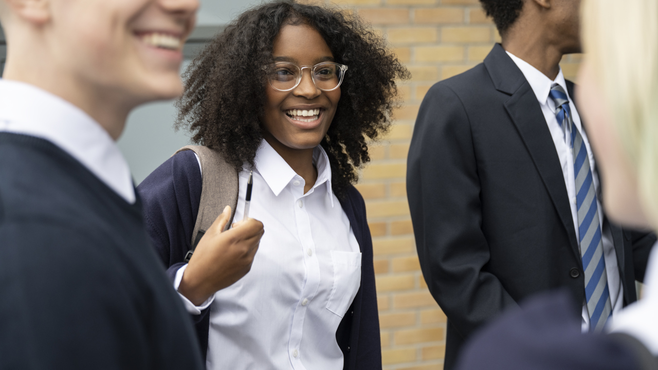 A group of young people talking outside school