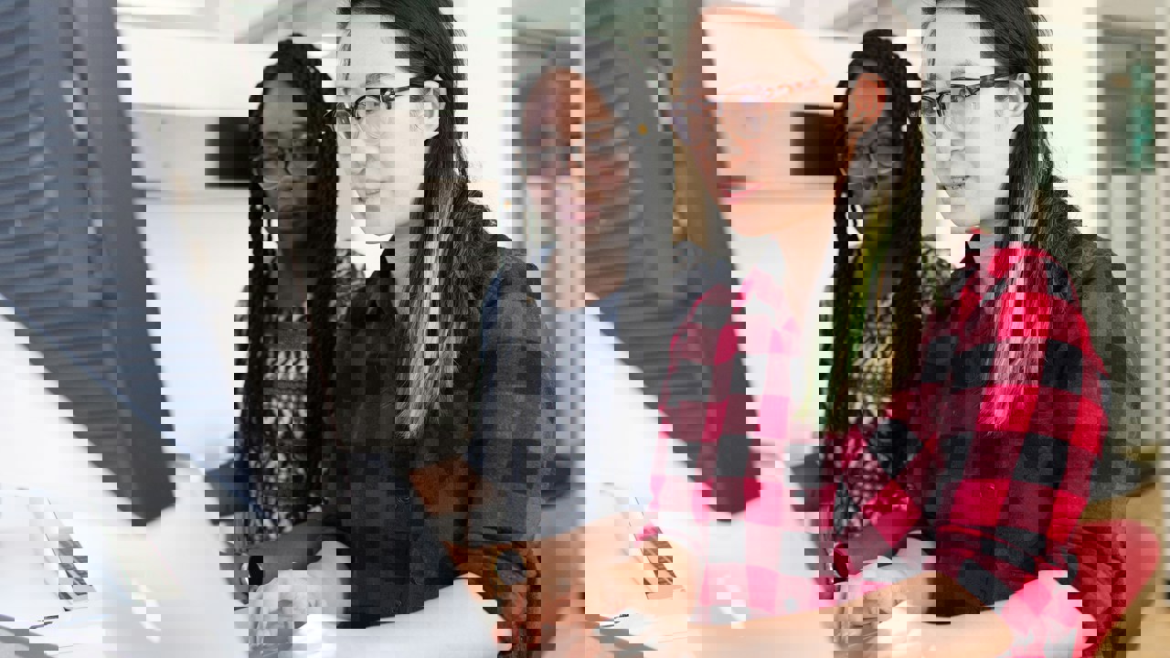 Two business professionals working at a computer