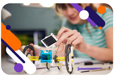 A young person working with a small model using equipment. There are graphics overlaid onto the image.