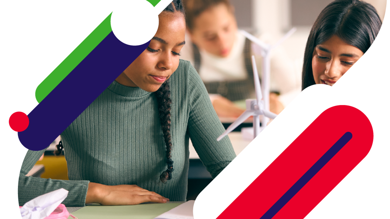 Close up shot of a group of young people building a model of a wind turbine in their science lesson.
