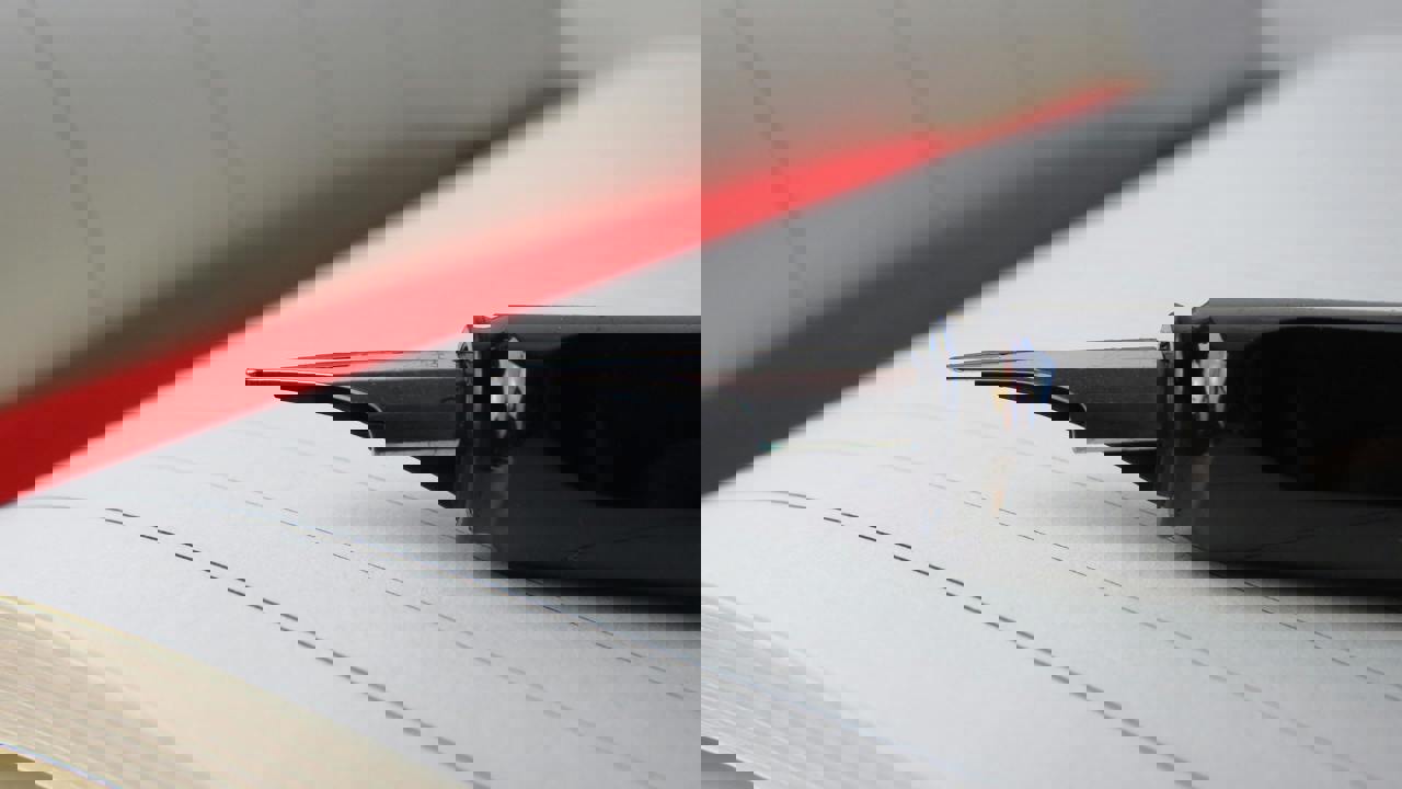 An open notebook with a pen lying on the page, close up