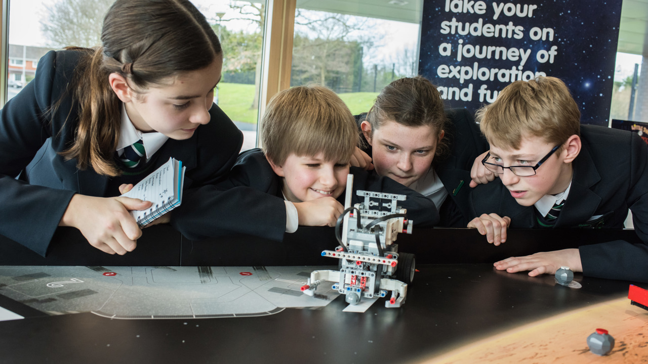 A group of young people build a robot